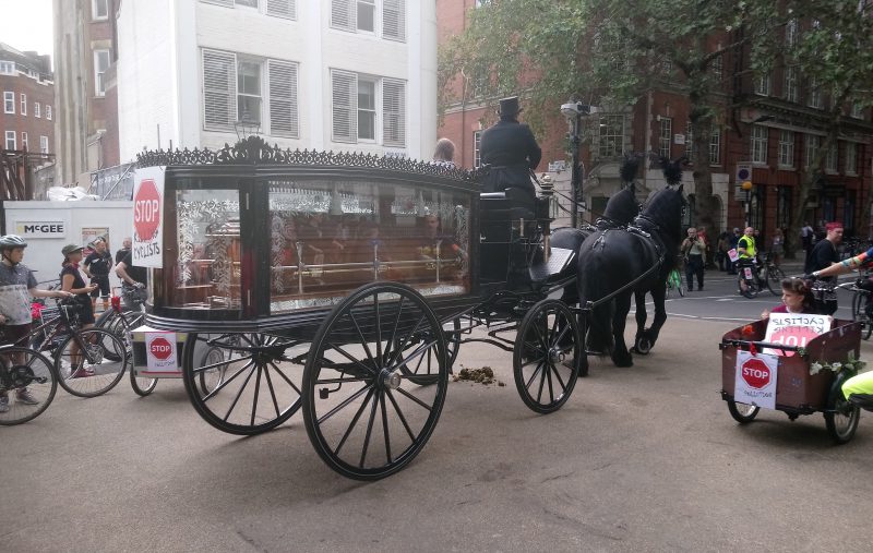 A horse drawn funeral carriage awaited